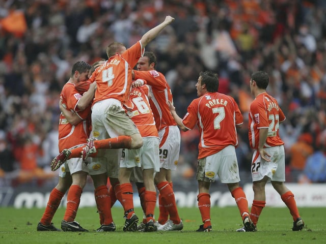 The Blackpool squad celebrate.