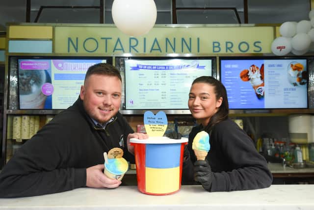 Notarianni Ices are raising money for Ukraine by selling blue and yellow ice cream packages. Pictured are Josh Johnson and Kerry Whitehead.