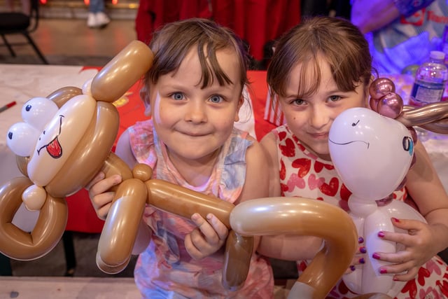 Maddison and Amelia Highfield have fun with a balloon monkey at the young carers' party at Blackpool Tower