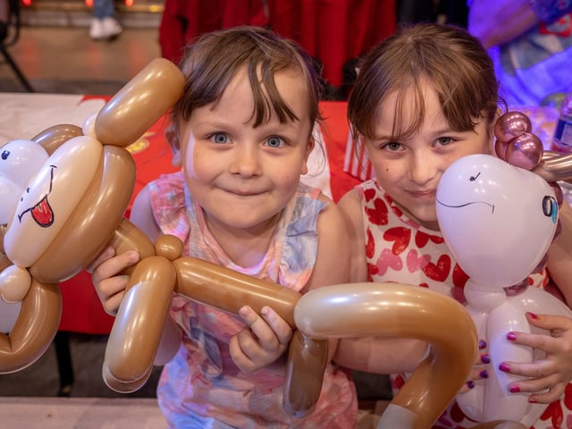 Maddison and Amelia Highfield have fun with a balloon monkey at the young carers' party at Blackpool Tower
