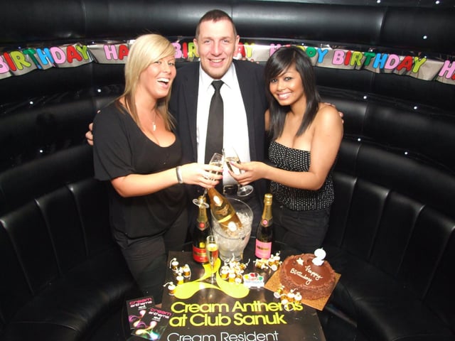 VIP hostesses Natalie Threlfall and Fairuz Aslam celebrate the club's first anniversary with Peter Bowden
