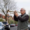 Musician Terry Reaney plays trumpet on his street during the 8pm clap for NHS