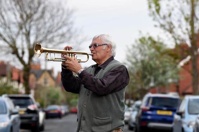 Musician Terry Reaney plays trumpet on his street during the 8pm clap for NHS