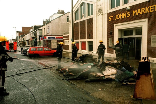 Firefighters bring a fire under control at the market in 1997