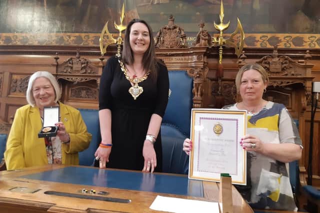 Blackpool Mayor Coun Amy Cross presents the Blackpool Medal to Coun Maxine Callow and her daughter Nancy in recognition of Peter Callow.