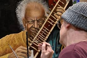 Artist Richard Marshall putting the finishing touches to one of his paintings