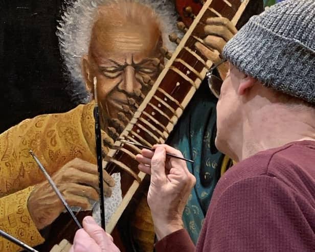 Artist Richard Marshall putting the finishing touches to one of his paintings