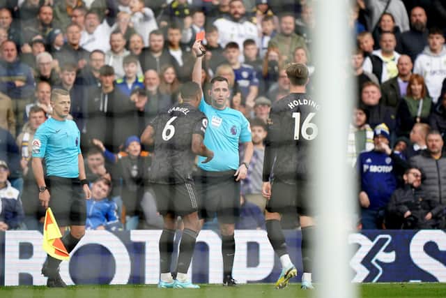 Arsenal's Gabriel is shown a red card by referee Chris Kavanagh during the Premier League match at Elland Road.