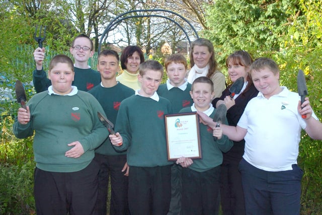 Pupils at Great Arley School in Thornton are celebrating after being awarded the North West In Bloom Commendation. L-R are Shaun Threlfall (11), Liam Lenihan (13), Dale Illingworth (13), Year 5 teacher Lorraine Hirst, Tommy Humphries (13), Dan Smith (13), Mellonie Thomas of Thornton In Bloom, Robert Unsworth (11), Harriet Samson (16) and Dean Carradice (12) 2003