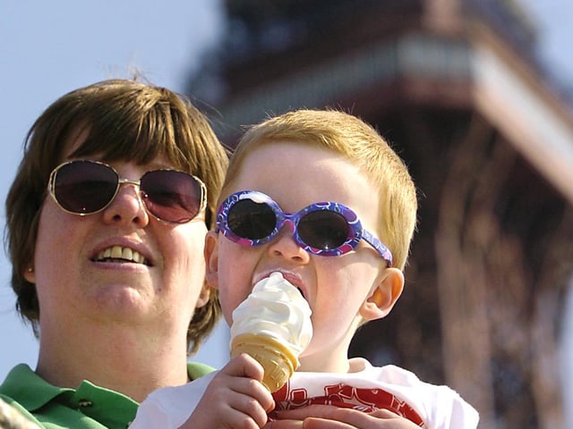 Two year old Matthew Hodgson, sporting his shades, enjoys ice cream in the sunshine with mum Karole, 2004