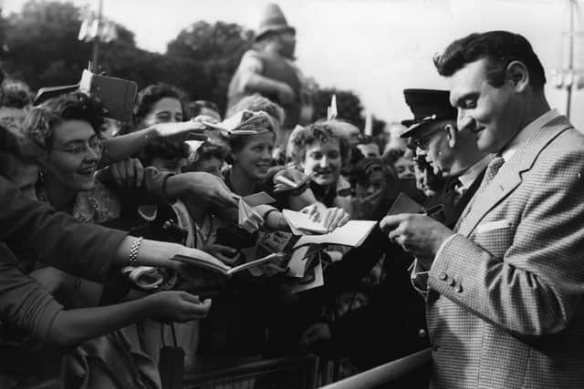 Singer Frankie Laine signs autographs for eager fans