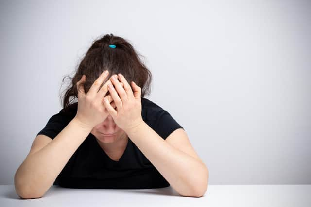 Stock image of a woman looking distressed. Credit: Manuel_Faba/Adobe