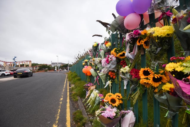 Hundreds of floral tributes and balloons to Kiena Dawes adorn Carlyle Avenue in Blackpool