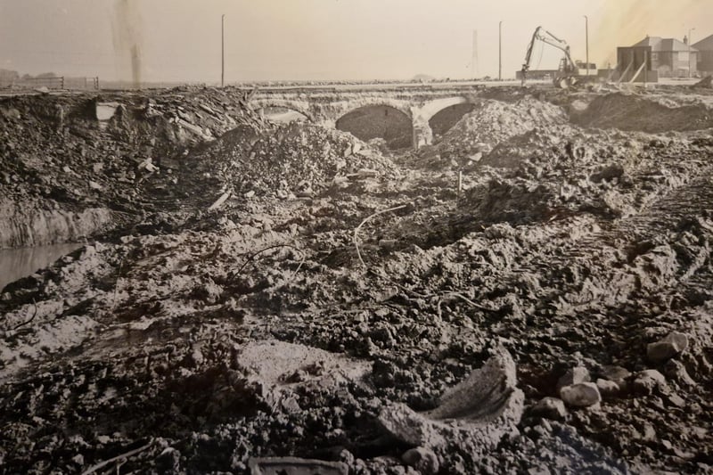 Peel Bridge, with parapets removed. Only the old railway archways are visible as the new roundabout at the end of the M55 takes shape