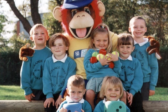 Funky Monkey with some infants from Grange Park Infants School after receiving an array of sports equipment from the Co-op Sports for Schools scheme, 1999