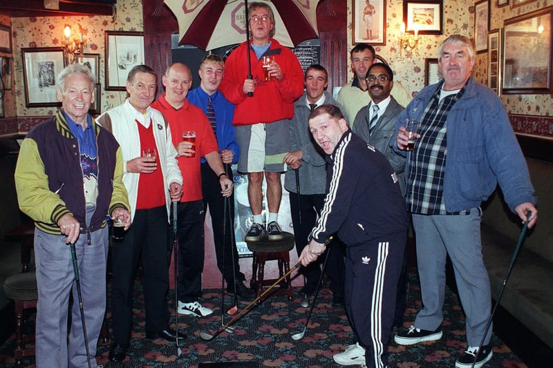 Wheatsheaf landlord Barrie Eastwood (back centre) with regulars on their new indoor driving range inside the pub