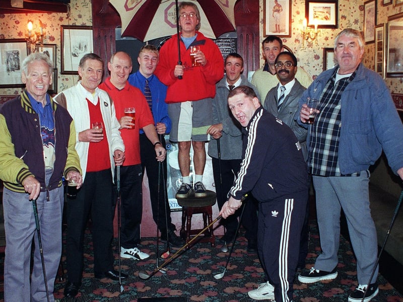 Wheatsheaf landlord Barrie Eastwood (back centre) with regulars on their new indoor driving range inside the pub