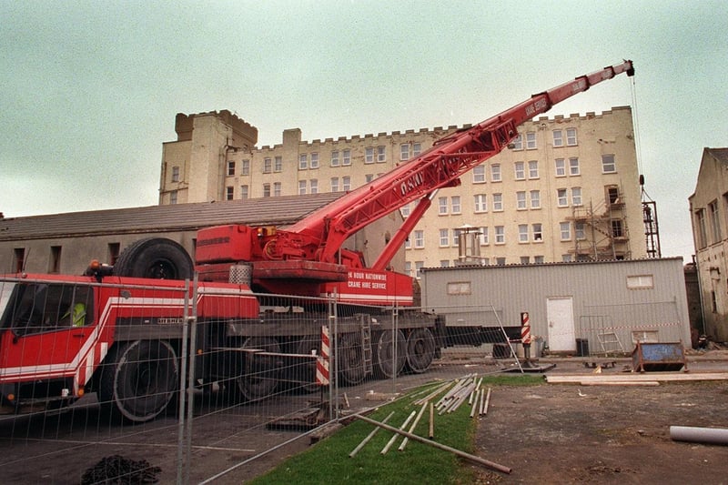 A giant crane removing a fire escape in 1998