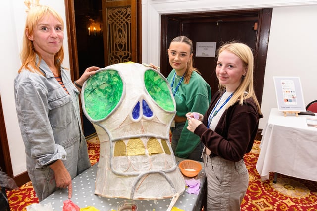 Left to right: Janine Walker shows off some of her work to pupils Hannah Summerfield and Fay Tomlinson