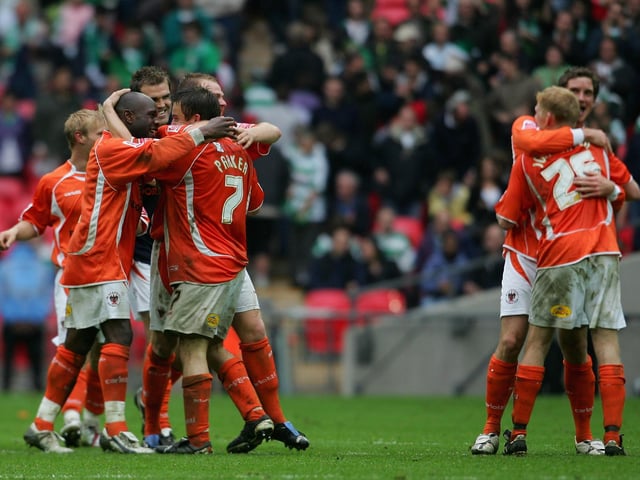 The Blackpool squad celebrate.