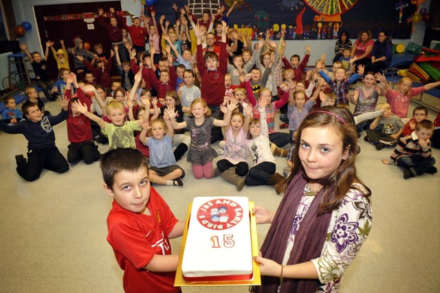 Jessica Davies and Christopher Longworth with members of Early Birds and JB's After School Club at Stanah Primary School, Thornton, celebrating the clubs 15th birthday