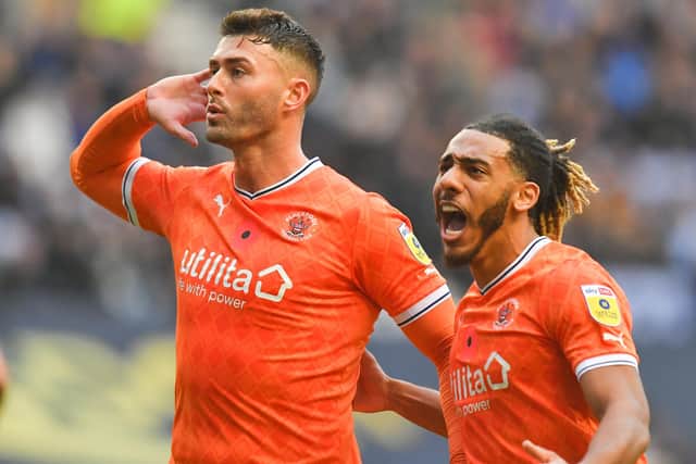 Gary Madine and Dom Thompson celebrate the former’s goal in Blackpool’s last game before the World Cup break at Wigan Athletic