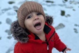 Elijah, 2, catching the snow on his tongue