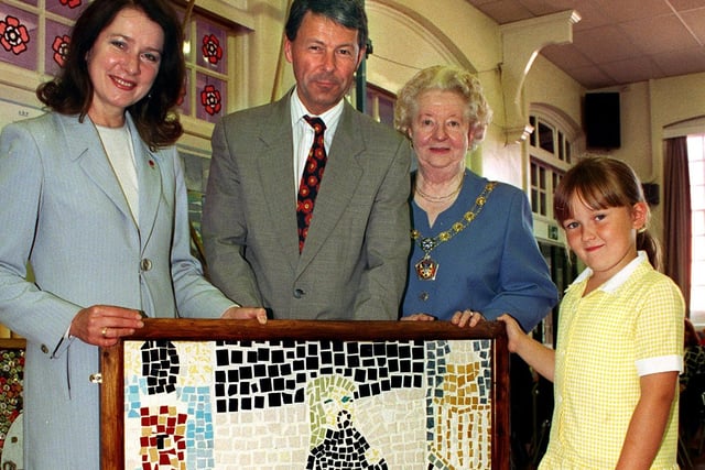 Seven year old Lauren Barlow shows one of the Chaucer Primary School mosaics , to Blackpool North and Fleetwood MP Joan Humble, headteacher Tim Gill and the Mayoress of Wyre Mrs Frances Taylor
