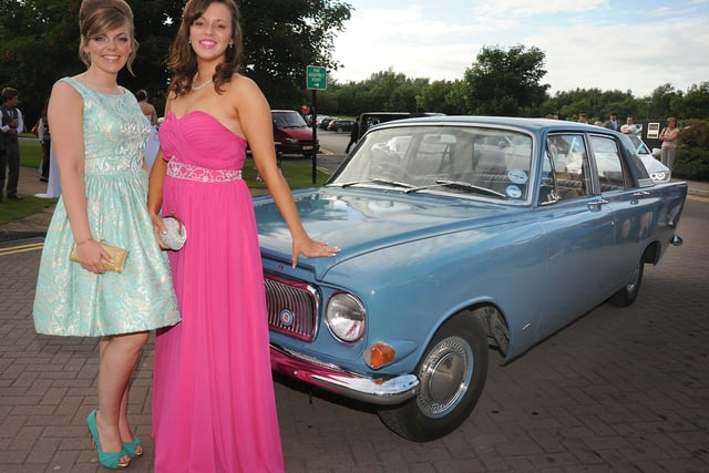 Aimee Hindle and Hannah Parkinson, from Cardinal Allen, pose next to their prom transportation, a classic Ford Zephyr