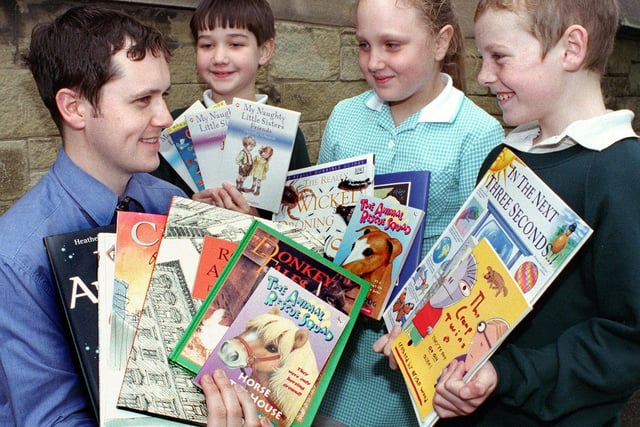 Former Gazette Education correspondent Austin Macauley hands over a box of books to children from St Kentigern's RC Primary School. With Austin, from left, James Lodge, Samantha Farley and Sean Kirton, 1998