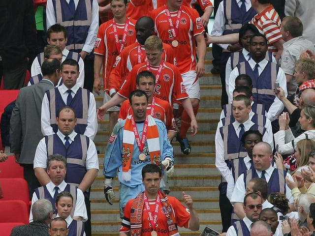 The Blackpool players walk down from the trophy presentation.