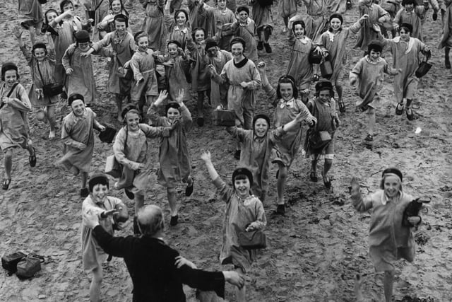 A crowd of happy children run toward Mr Brown, the superintendent of the Blackpool holiday home they were enjoying which offered a sea side break for poor children in the Manchester area