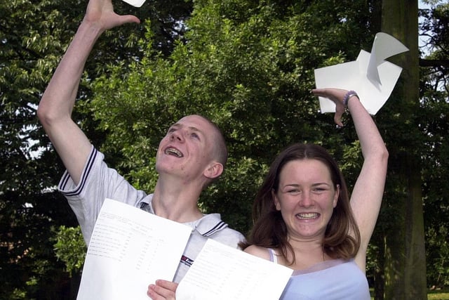 St Bede's High School students Matthew Craddock and Jenny Riley (head boy and girl) throw away their notes after passing their GCSE exams