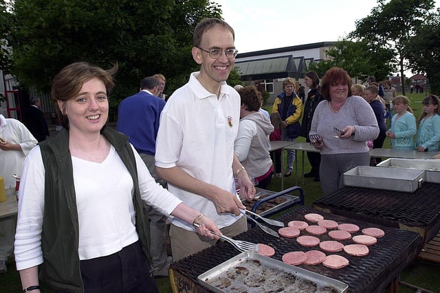 English teacher Serena Molloy and head David Tansey man the barbecue at Beacon Hill High School's first anniversary celebration, 2000