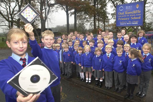 Children from Out Rawcliffe Primary School with their CD which is being sold to raise money for a school extension. The kids will also be singing on radio Lancashire. Pictured (front left to right) holding the CDs are Linda Wood, 10, and Philip Brown, 11, with the rest of their classmates looking on