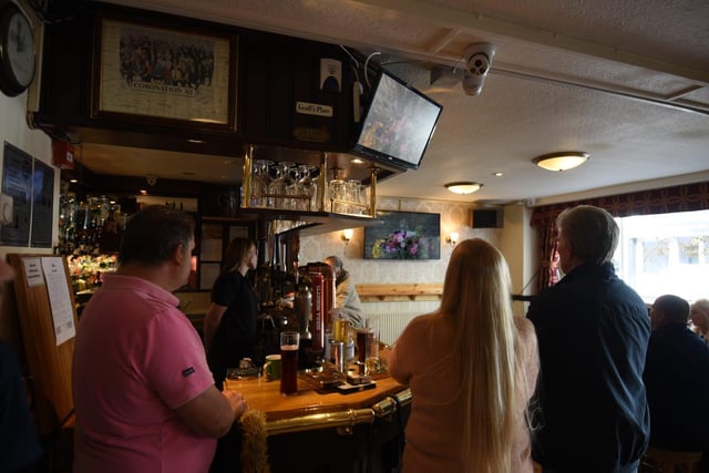 Locals watch the funeral in The Mitre pub in Blackpool.