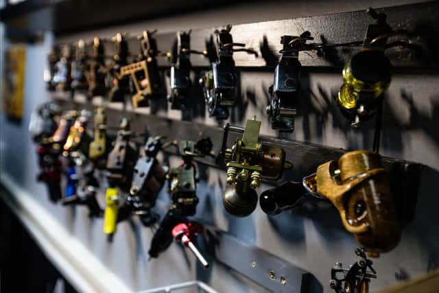 A collection of tattoo machines — tools that helped shape the early days of modern tattooing. Photo: Adam Spencer Young.