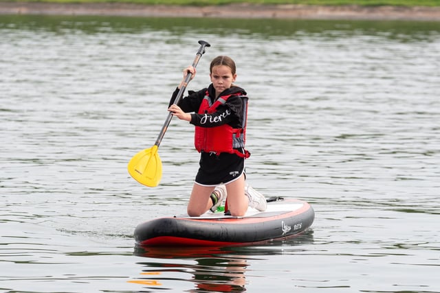 A youngster tries her hand at paddle boarding at the Fairhaven Regatta. Photo: Kelvin Lister-Stuttard