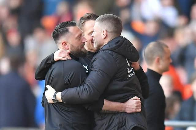 Dobbie celebrating Saturday's win against Wigan with his backroom staff