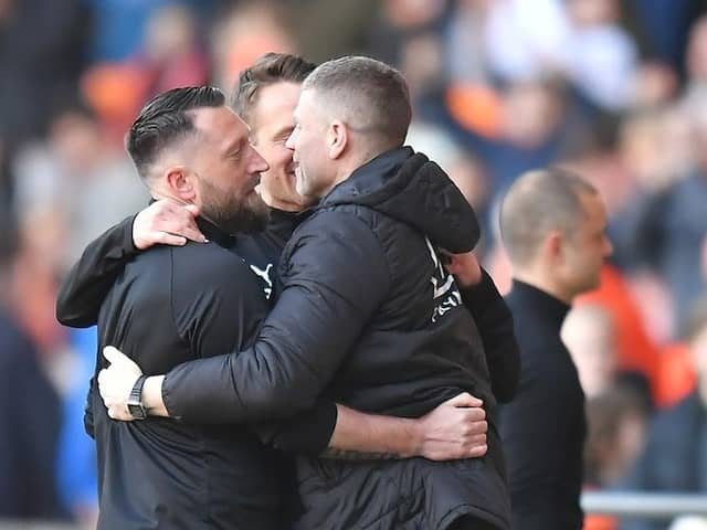 Dobbie celebrating Saturday's win against Wigan with his backroom staff