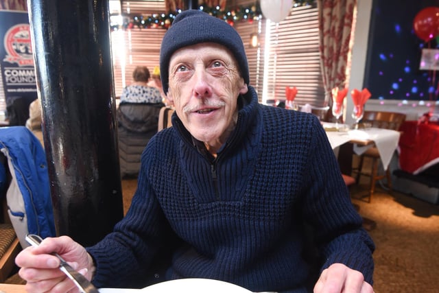 Mike Blainey enjoying a hearty plate full of food covered in gravy