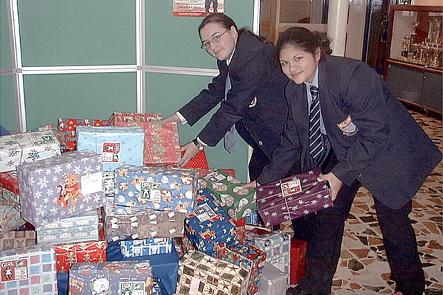 Collegiate High School pupils Kelly Lam and Kathrine Mladenovic, sorting out the donations for operation Christmas Child in 2001