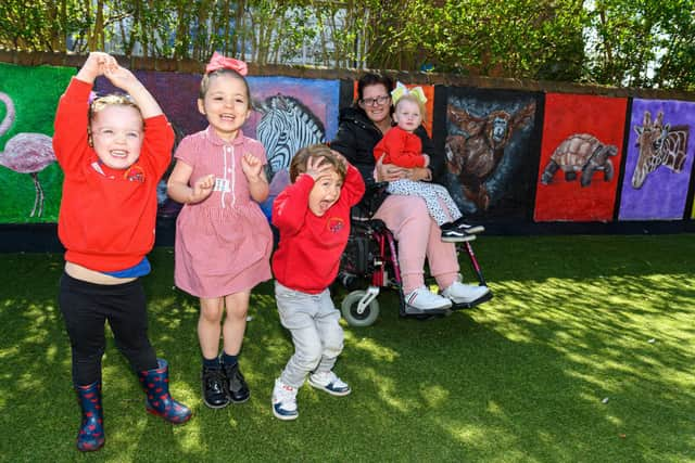 (l-r) Amelia Fairchild, Maisie Daniels, Daniel Martinez Inigo and Esmé Jones with artist Kirsty Rea and the zoo mural at Ashcroft Nursery in Blackpool. Photo: Kelvin Stuttard