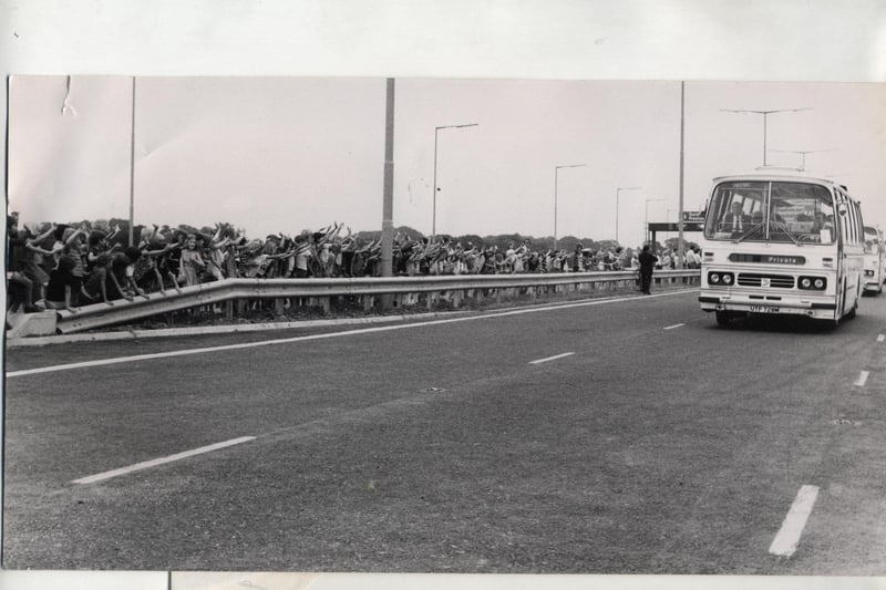 Children from Broughton School wave to the minister on the start of his tour of the motorway by coach at the M55 opening ceremony in 1975