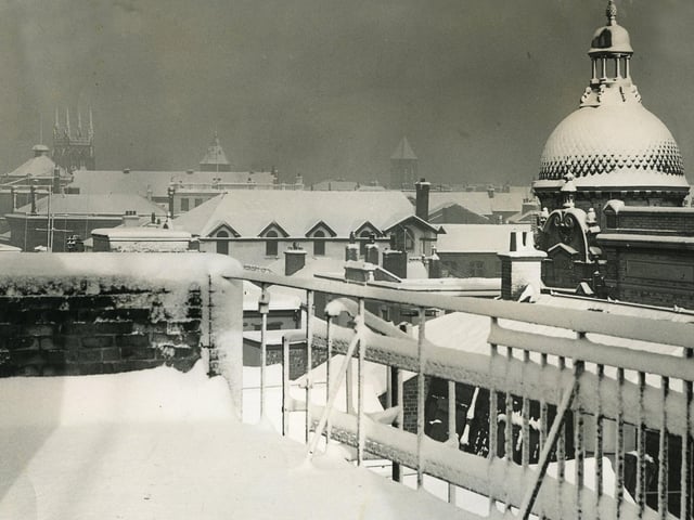 View from the top of the Evening Gazette building in Victoria Street Blackpool looking north on a snowy day in 1958. The rotunda of Yates's Wine lodge is on the left, to it's right is Sacred Heart Church on Talbot Road and next to it is the tower of Sacred Heart School. Further right is the tower of Christ Church which was situated on the corner of Abingdon Street and Queen Street and replaced by what is now the job centre.The dome of The Grand Theatre is prominent on the right ( with a seagull on it's spire).
The nearby roof with dormer windows is Rawcliffe's Outfitters on Church Street