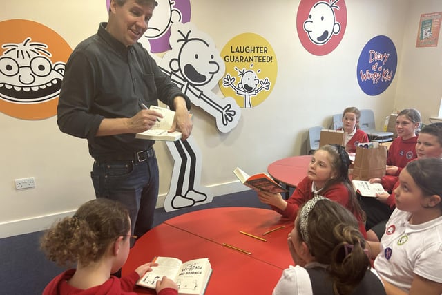 Jeff Kinney is still writing during his visit to  Our Lady of the Assumption