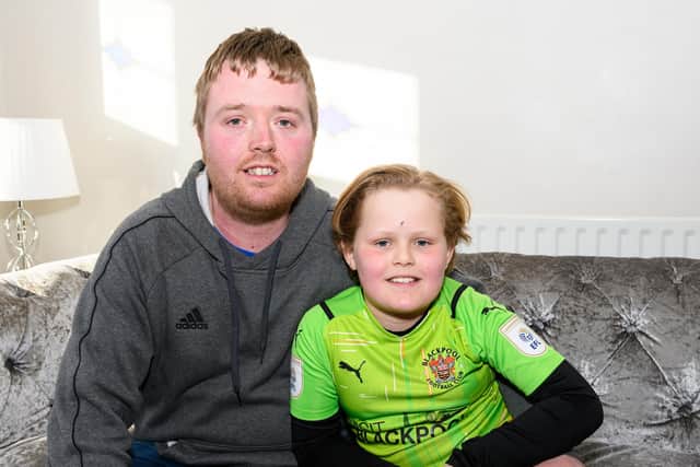 Jordan Kayley with his son Harry Slavin-Kayley, 8, who suffered a deep cut on his forehead after rowdy Preston fans at the Blackpool V Preston match threw an empty light fluid can at him. Photo: Kelvin Stuttard