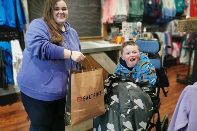 Young Kaason Ogden with a helpful member of staff at Saltrock, based at the Affinity retail park in Fleetwood.