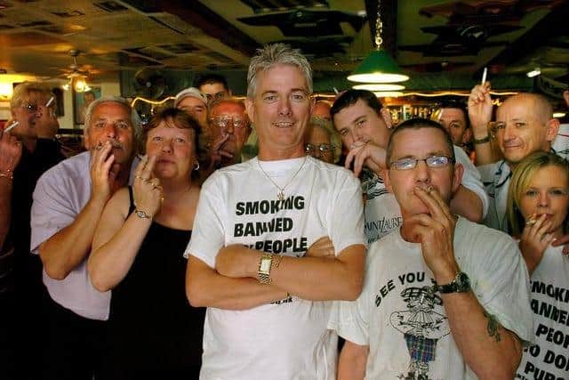 
Hamish Howitt (centre) with customers flouting the 2007 smoking ban at the Happy Scots Bar in Rigby Road, Blackpool.

