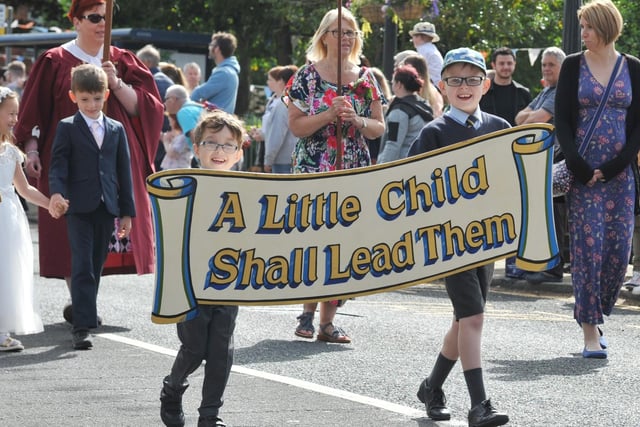 Members of the community take part in the Freckleton Club Day procession through the village.